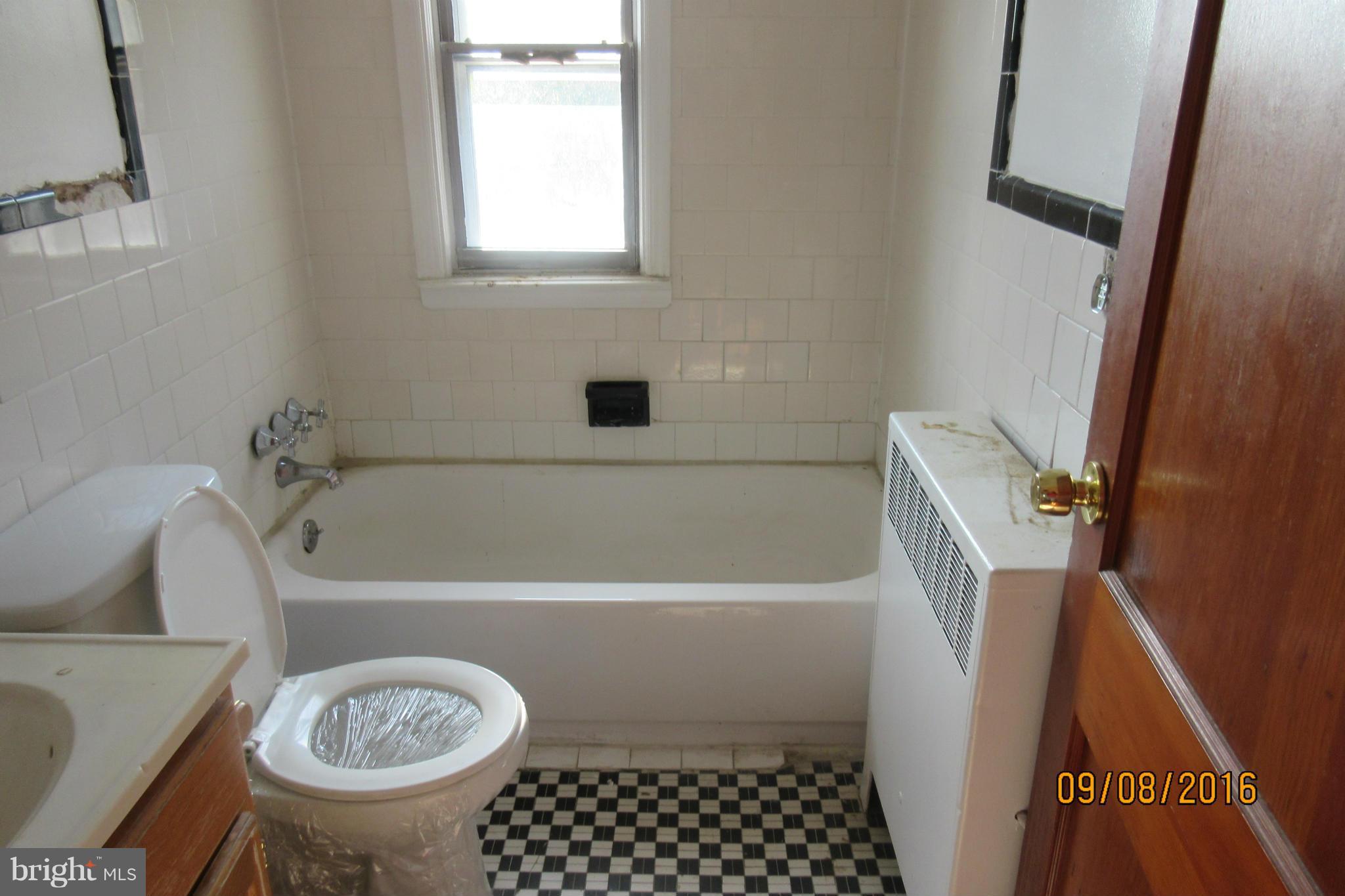 3919 Colchester Road Baltimore, MD 21229 - Photo 13 of 13 a bathroom with a sink a bathtub and a toilet