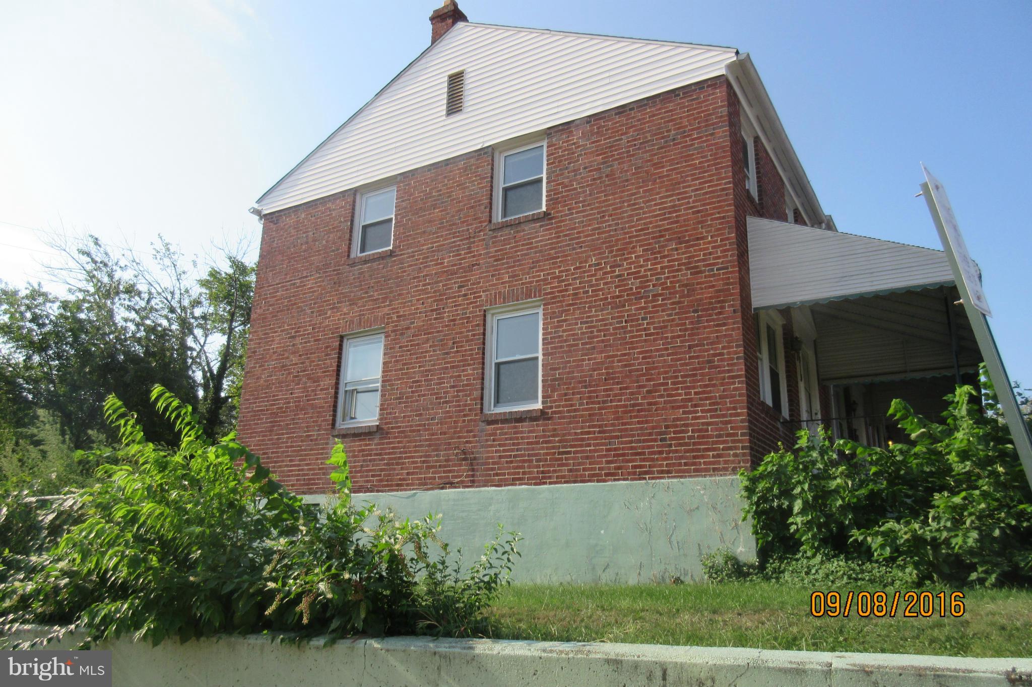 3919 Colchester Road Baltimore, MD 21229 - Photo 3 of 13 a front view of a house with a yard