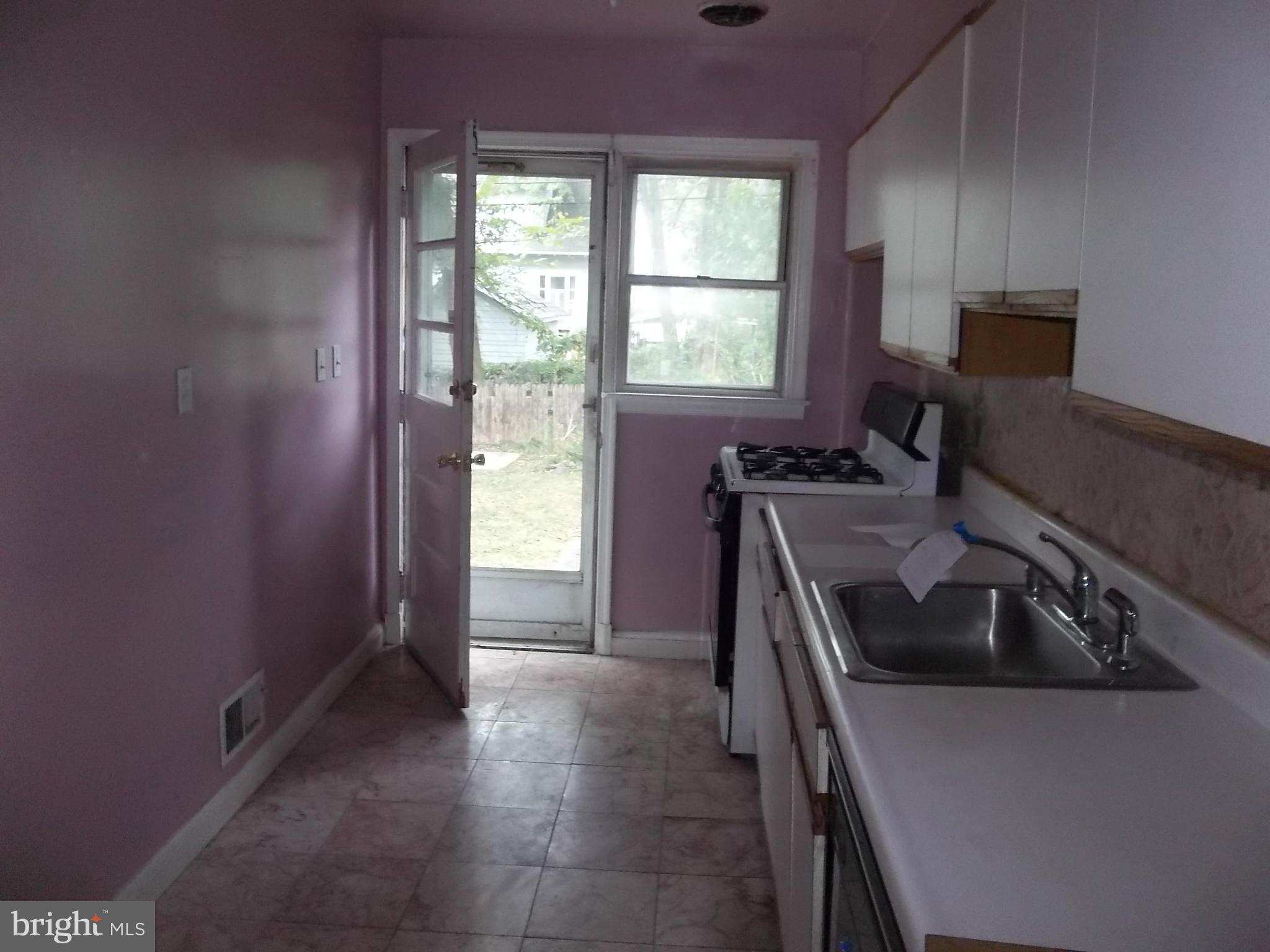 3919 Colchester Road Baltimore, MD 21229 - Photo 8 of 13 a kitchen that has a sink and a stove