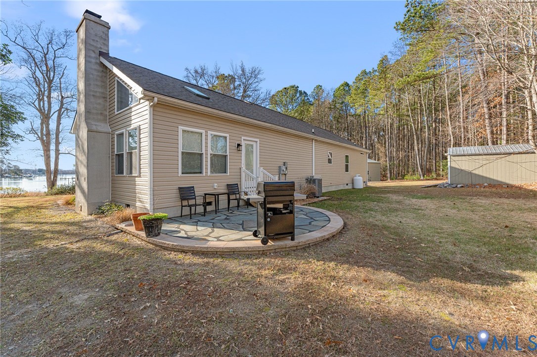 613 Doctors Point Road Lottsburg, VA 22511 - Photo 16 of 50 a view of a house with backyard and sitting area