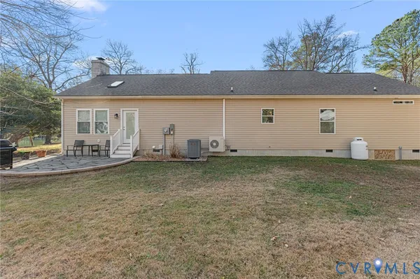 a backyard of a house with table and chairs