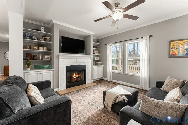 a living room with furniture window and a fireplace