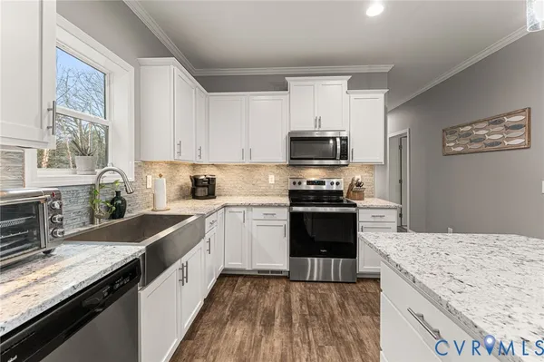 a kitchen with granite countertop a sink stove and refrigerator