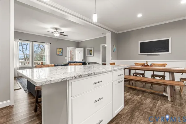 a living room with granite countertop furniture and a flat screen tv