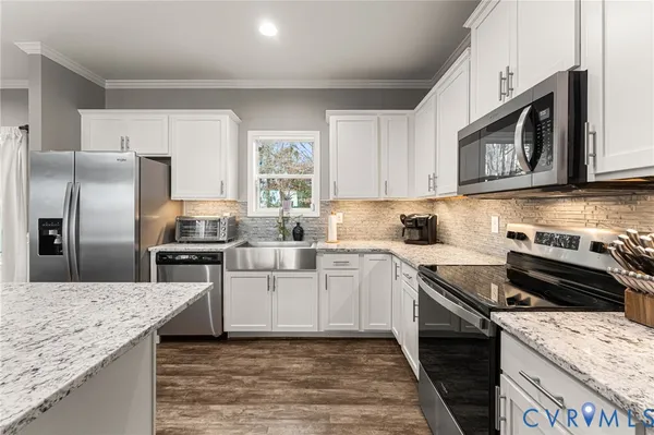 a kitchen with a sink stove and refrigerator