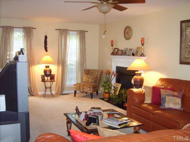 The large and spacious living room has upgraded lighting, gas fireplace with mantle, and convenient access to the deck and backyard. Living Room