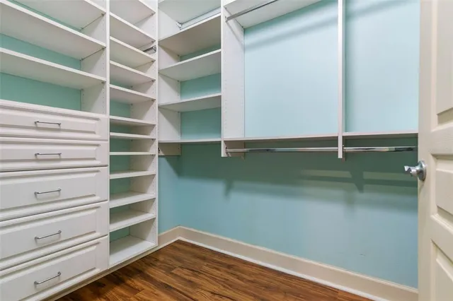 a spacious bedroom with a bed and a chandelier
