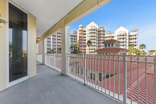 a view of a swimming pool with a table and chairs under an umbrella