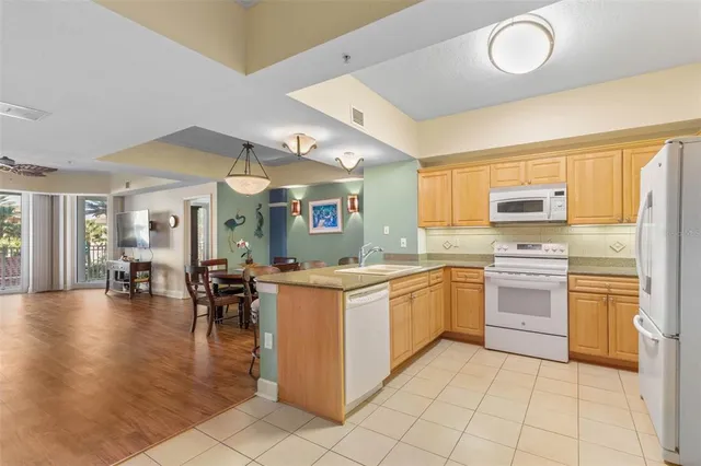 a kitchen with stainless steel appliances granite countertop a sink and cabinets