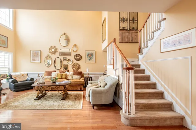 a living room with furniture and a chandelier