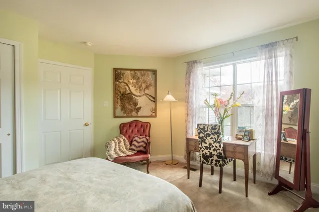 a bedroom with a bed and a table in it