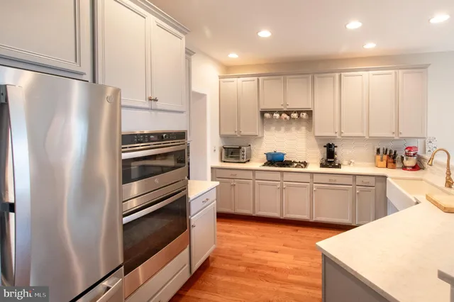 a kitchen with a refrigerator and a sink