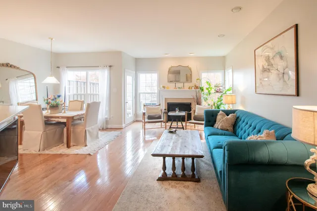 a living room with furniture a fireplace and a large window