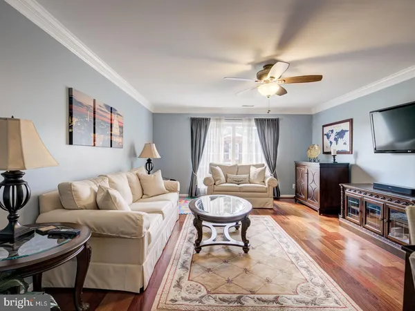 a living room with furniture a window and a flat screen tv
