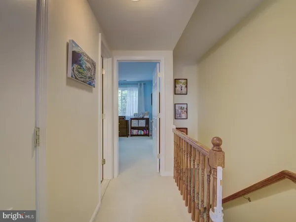 a view of a hallway to a livingroom with a furniture