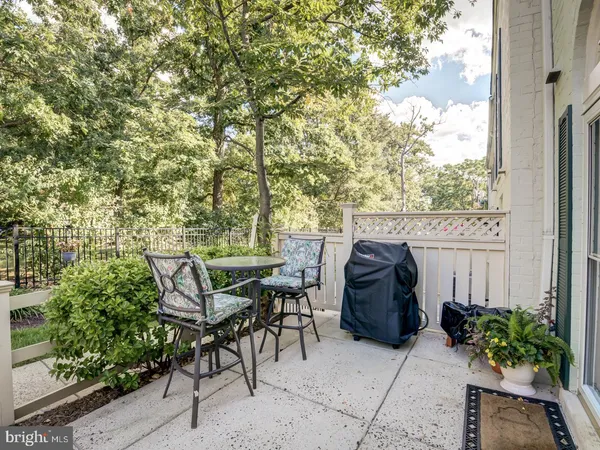 a view of a patio with table and chairs and potted plants