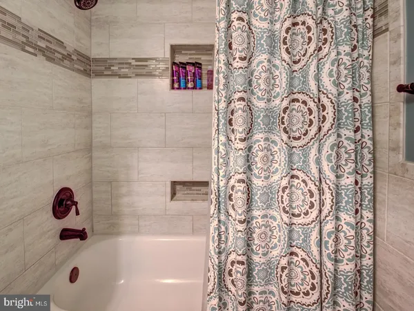 a bathroom with a bathtub and shower