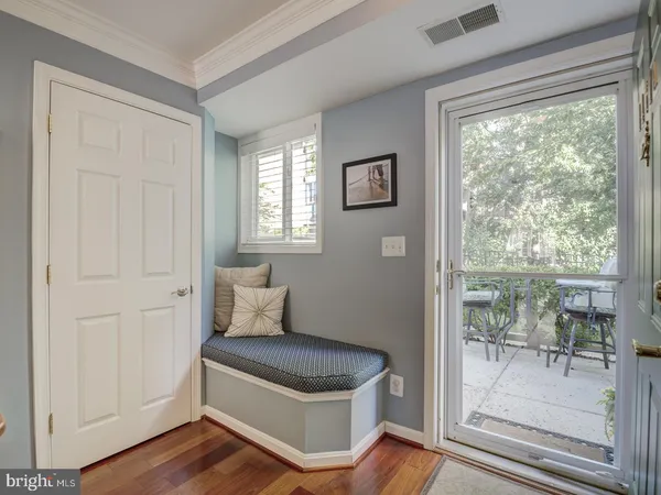 a living room with a wooden floor and a table