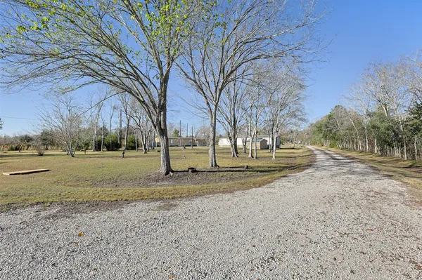 a view of dirt yard with a house