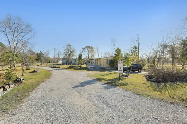 a view of yard with swimming pool and trees