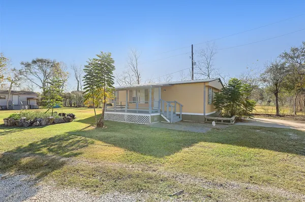 a view of a yard with yellow house