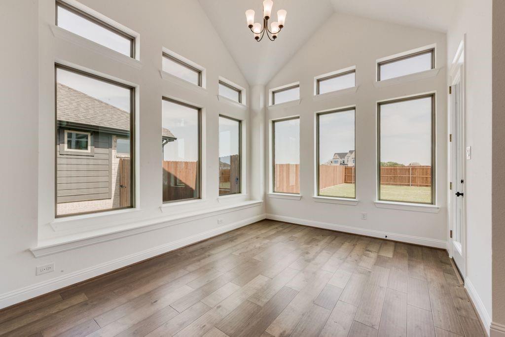 511 San Angelo Drive Forney, TX 75126 - Photo 13 of 34 a view of an empty room with wooden floor and a window