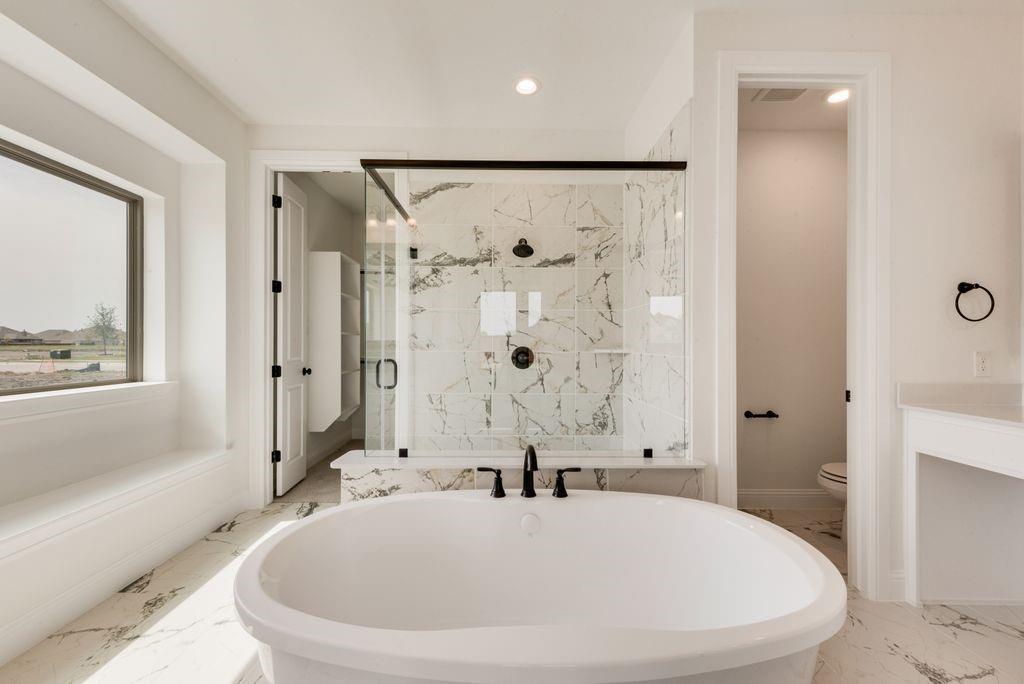 511 San Angelo Drive Forney, TX 75126 - Photo 17 of 34 a white bath tub sitting next to a white sink