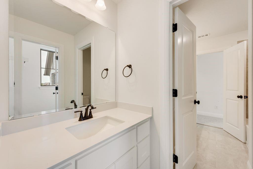 511 San Angelo Drive Forney, TX 75126 - Photo 23 of 34 a bathroom with a sink and a mirror