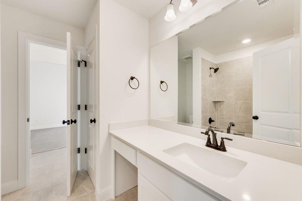 511 San Angelo Drive Forney, TX 75126 - Photo 24 of 34 a bathroom with a sink and a mirror