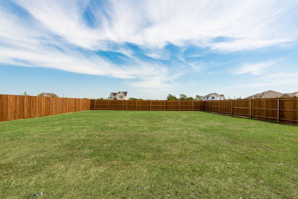 511 San Angelo Drive Forney, TX 75126 - Photo 30 of 34 a view of an outdoor space and a yard