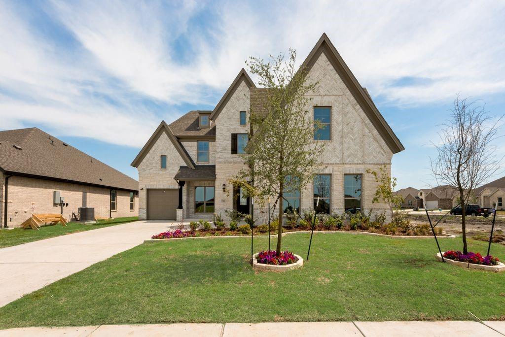 511 San Angelo Drive Forney, TX 75126 - Photo 3 of 34 a front view of a house with a yard
