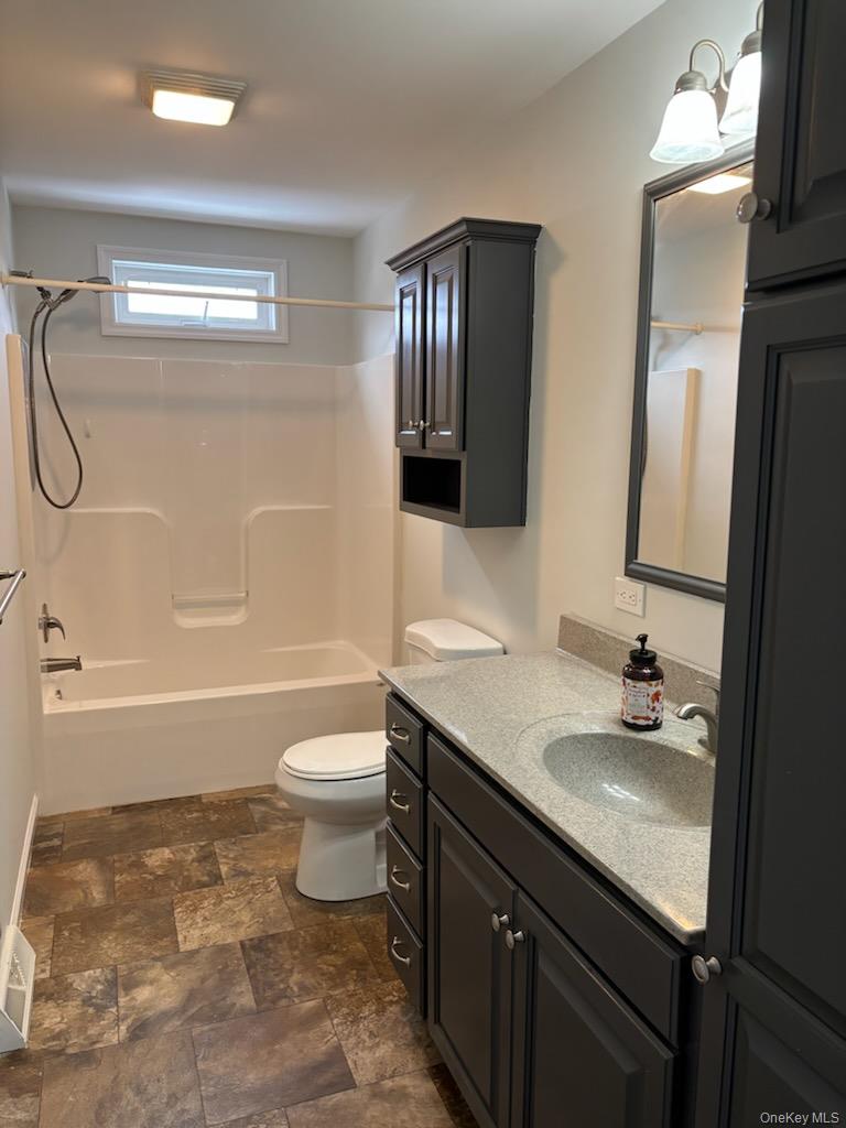 1661 Old Country Road, Unit 539 Riverhead, NY 11901 - Photo 15 of 26 a bathroom with a sink a toilet and shower