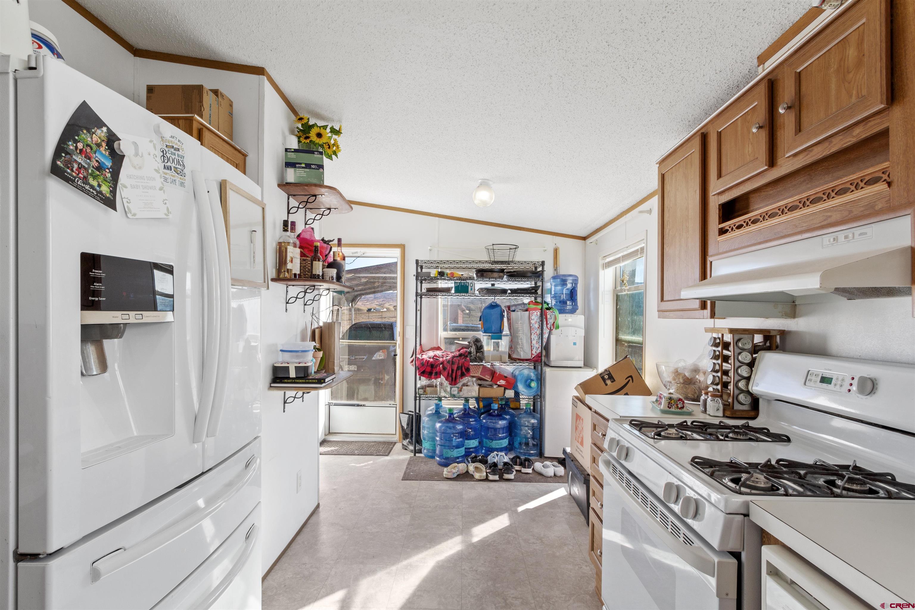 23384 D50 Road Delta, CO 81416 - Photo 13 of 37 a kitchen with stainless steel appliances granite countertop a stove and cabinets