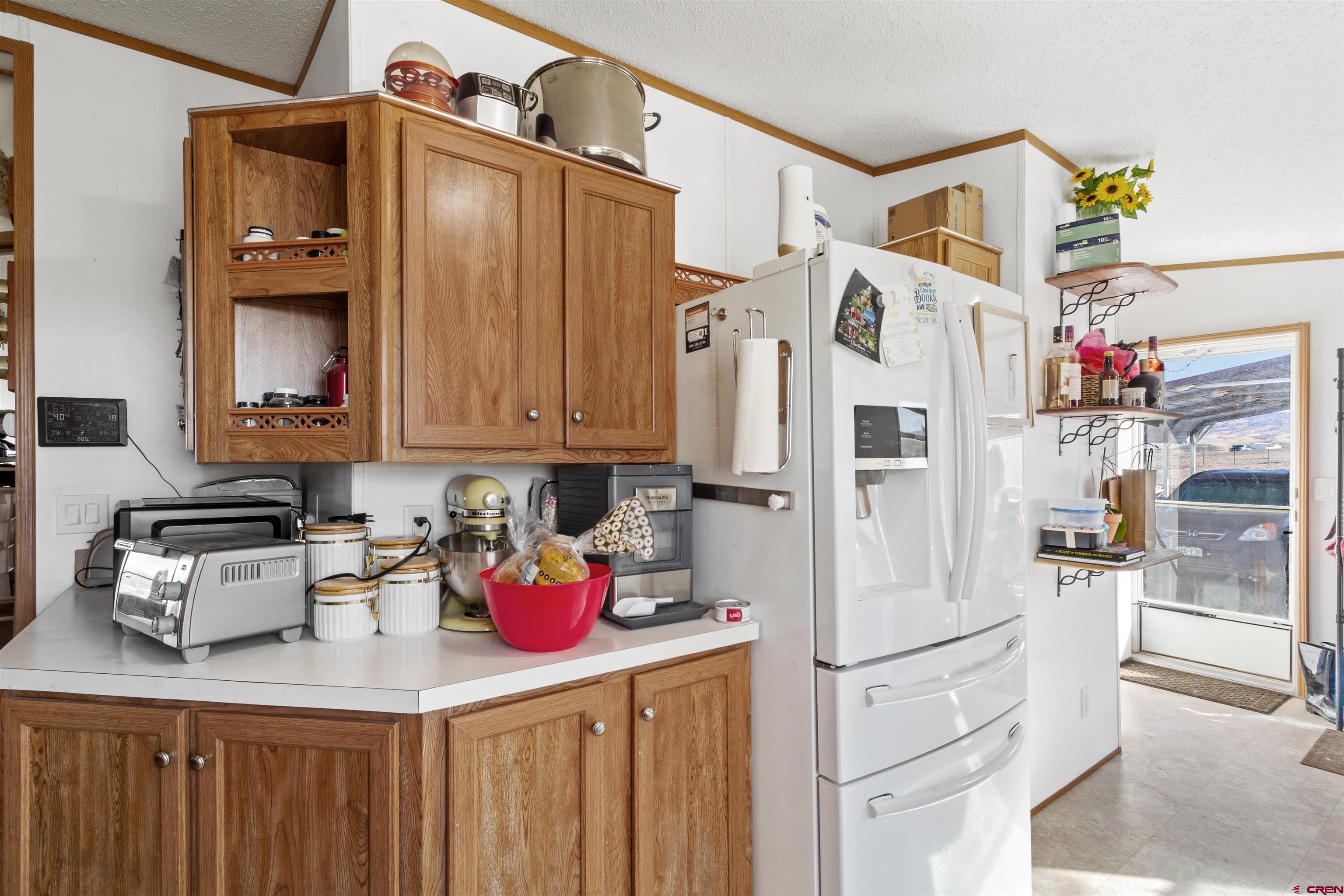 23384 D50 Road Delta, CO 81416 - Photo 14 of 37 a kitchen with a refrigerator a stove and cabinets