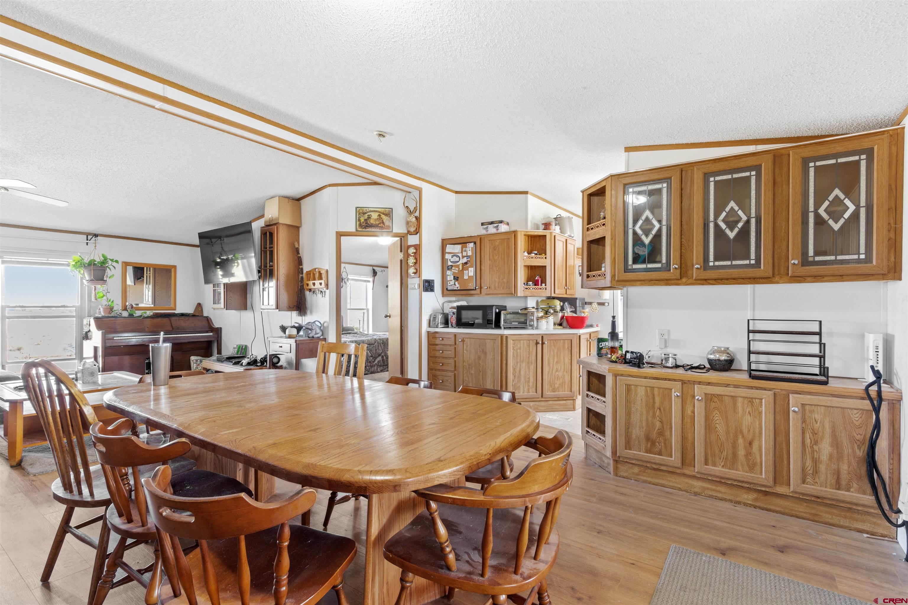 23384 D50 Road Delta, CO 81416 - Photo 17 of 37 a dining room with stainless steel appliances granite countertop a dining table and chairs with wooden floor