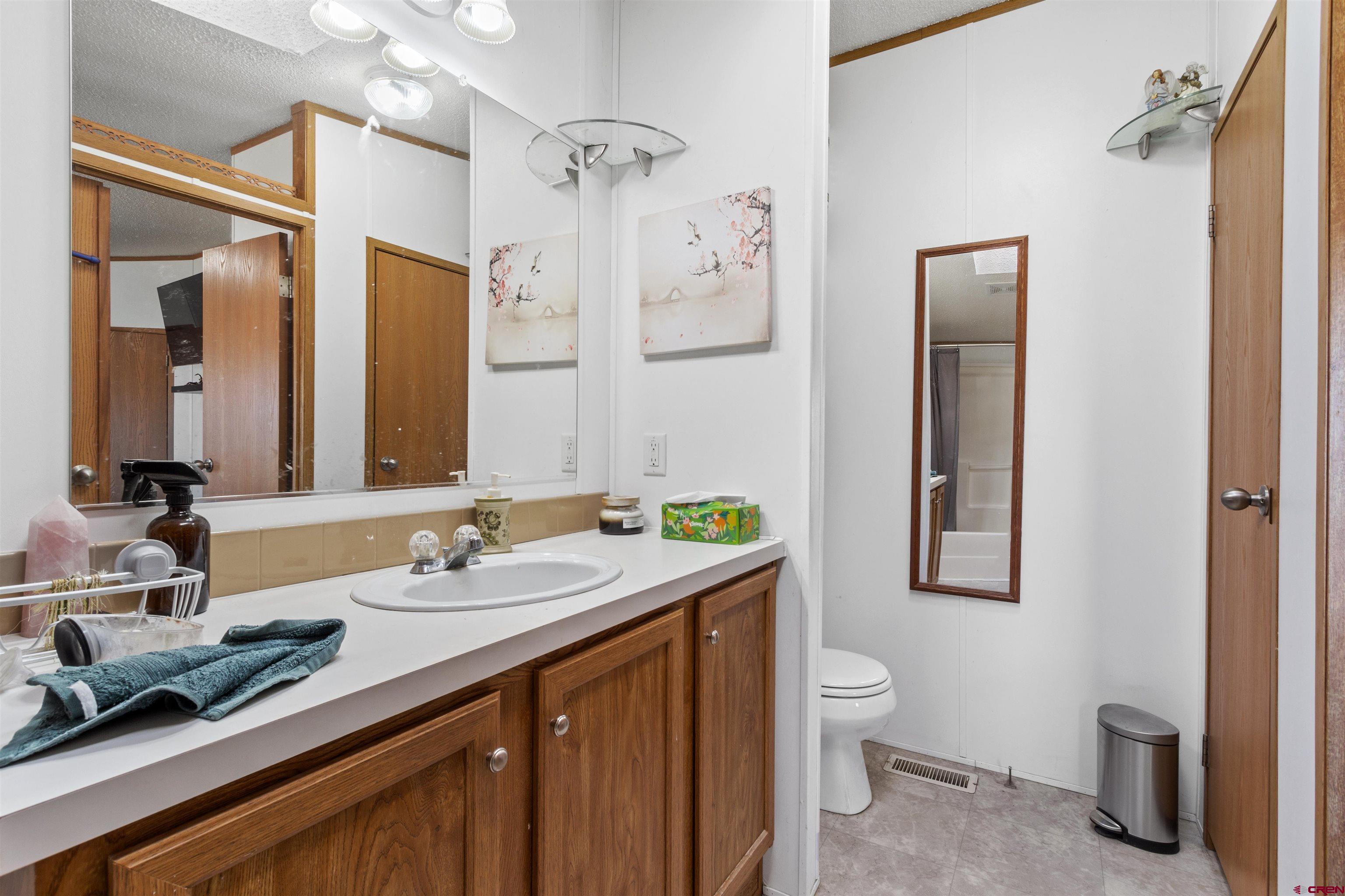 23384 D50 Road Delta, CO 81416 - Photo 25 of 37 a bathroom with a double vanity sink and a mirror