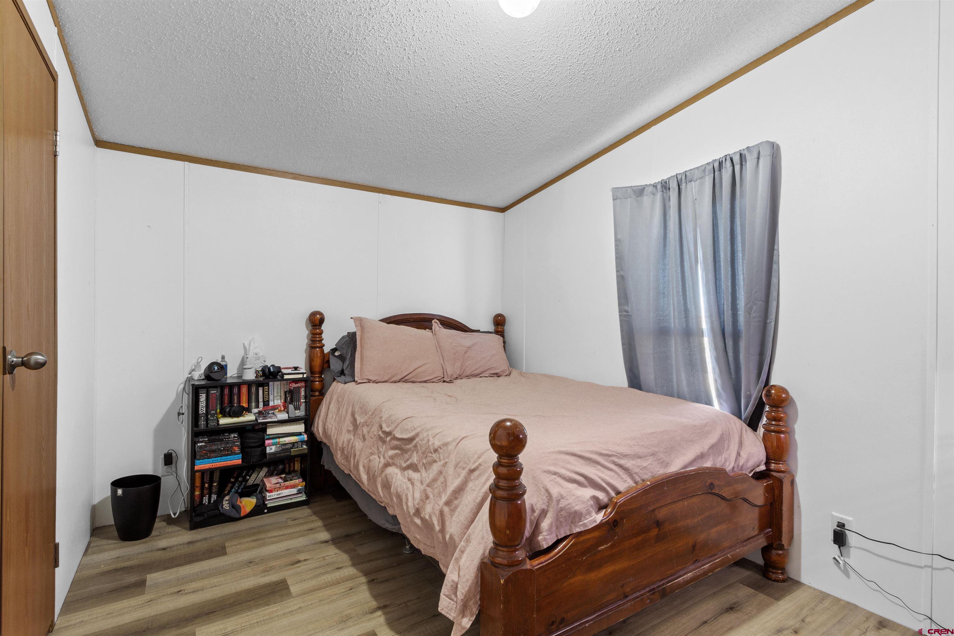 23384 D50 Road Delta, CO 81416 - Photo 29 of 37 a bedroom with a bed and a large mirror