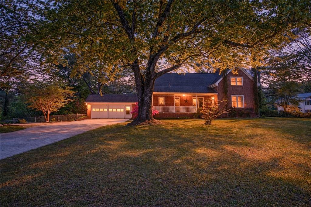 a view of a large tree in front of a house