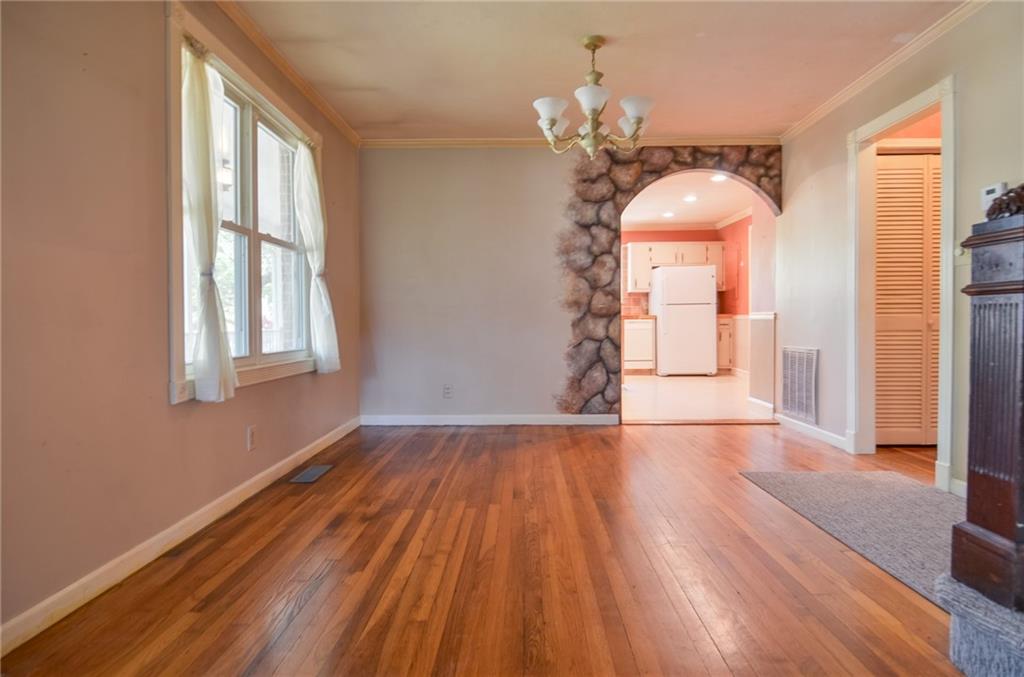 716 Killian Hill Road Southwest Lilburn, GA 30047 - Photo 16 of 56 a view of empty room with wooden floor and fan