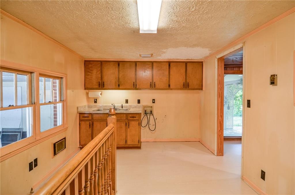 716 Killian Hill Road Southwest Lilburn, GA 30047 - Photo 24 of 56 a view of a kitchen with furniture and stainless steel appliances