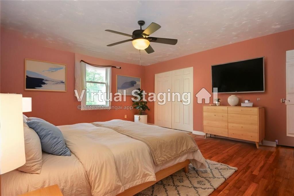 716 Killian Hill Road Southwest Lilburn, GA 30047 - Photo 26 of 56 a bedroom with a bed and a flat screen tv