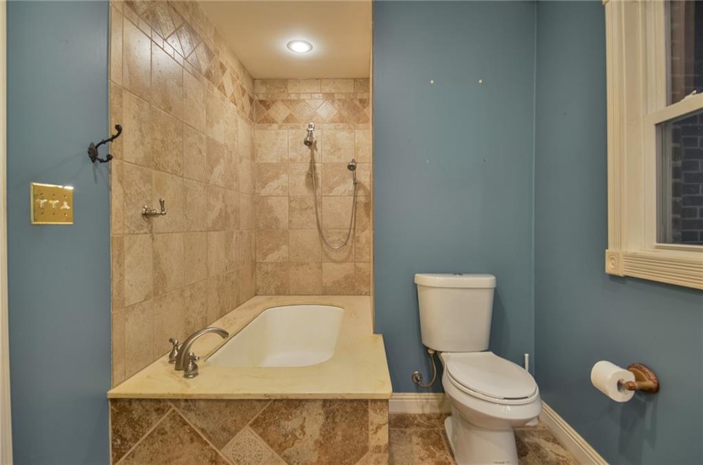 716 Killian Hill Road Southwest Lilburn, GA 30047 - Photo 30 of 56 a bathroom with a sink a toilet and shower