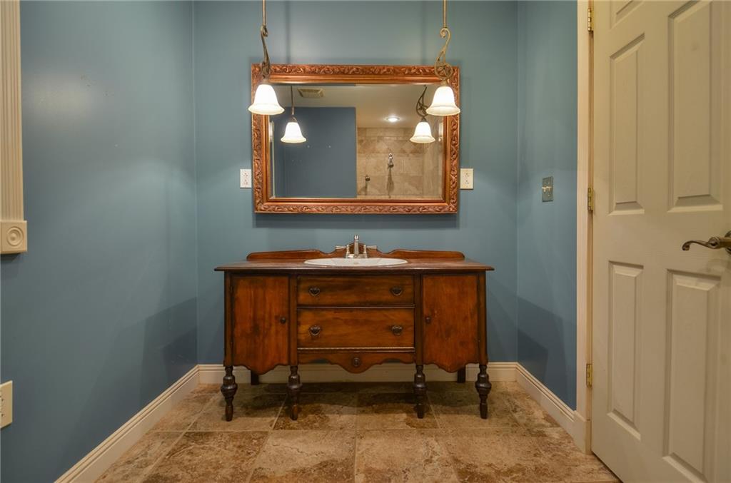 716 Killian Hill Road Southwest Lilburn, GA 30047 - Photo 31 of 56 a bathroom with a sink and a mirror