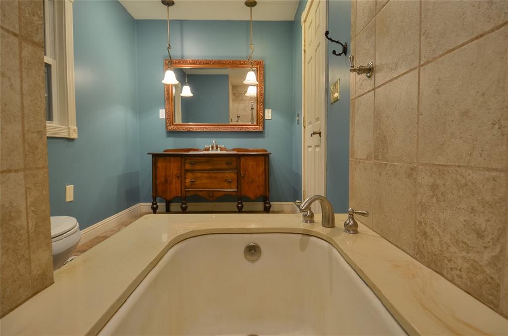 716 Killian Hill Road Southwest Lilburn, GA 30047 - Photo 32 of 56 a bathroom with a bathtub and a sink