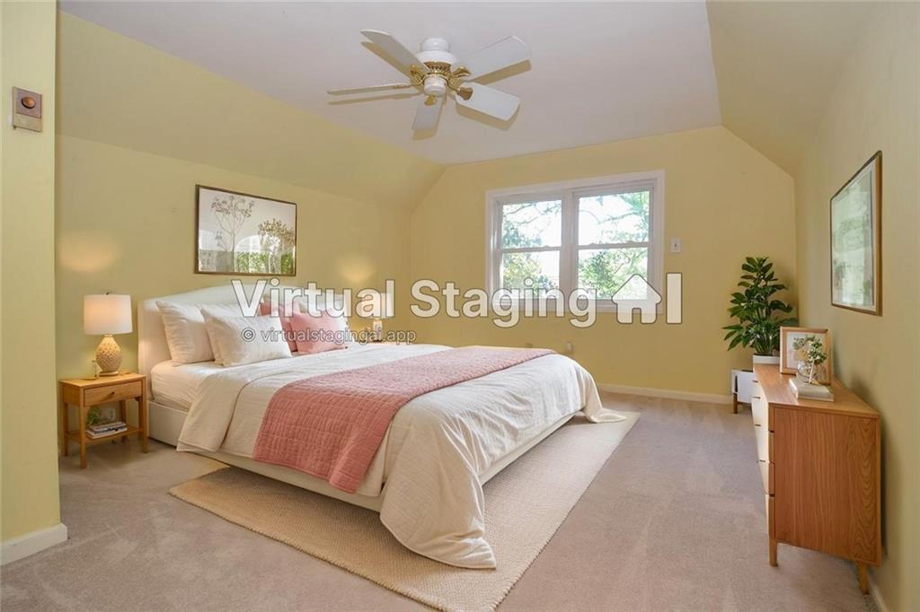 716 Killian Hill Road Southwest Lilburn, GA 30047 - Photo 34 of 56 a bedroom with a bed and a chandelier