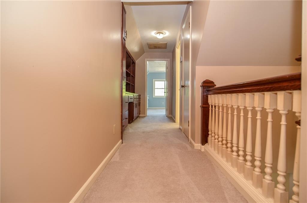 716 Killian Hill Road Southwest Lilburn, GA 30047 - Photo 40 of 56 a view of a hallway with wooden floor and a chandelier