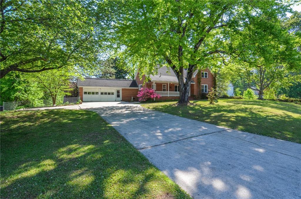 716 Killian Hill Road Southwest Lilburn, GA 30047 - Photo 4 of 56 a view of a house with a yard and sitting area