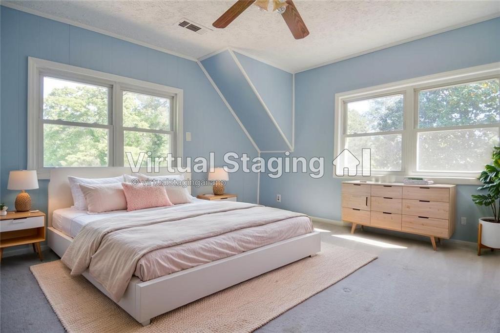 716 Killian Hill Road Southwest Lilburn, GA 30047 - Photo 44 of 56 a bedroom with a bed and a window