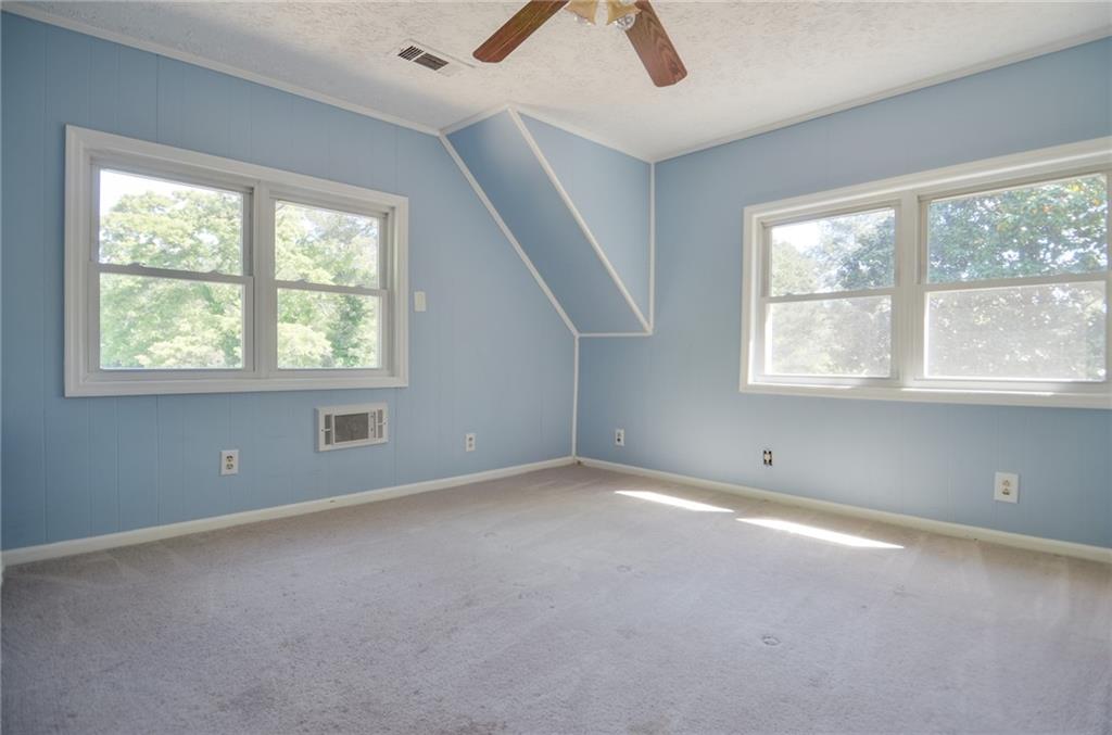 716 Killian Hill Road Southwest Lilburn, GA 30047 - Photo 45 of 56 an empty room with a window and a ceiling fan