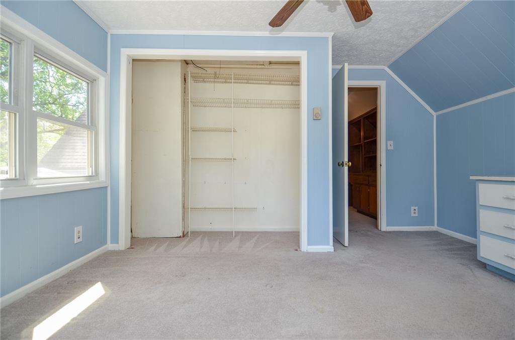 716 Killian Hill Road Southwest Lilburn, GA 30047 - Photo 47 of 56 an empty room with windows and closet